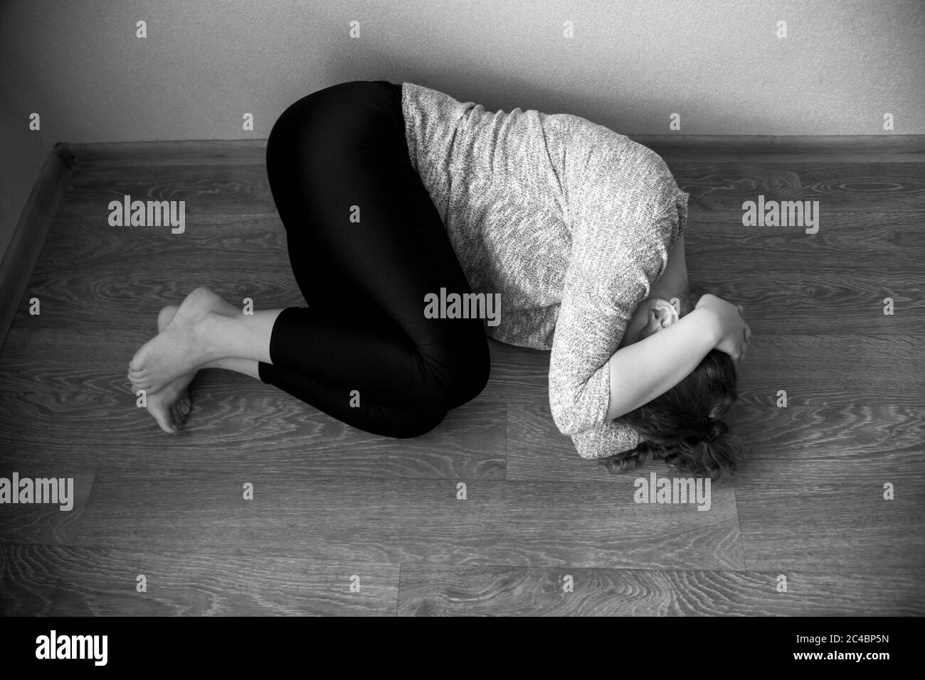 Young woman lying on the floor Black and White Stock Photos & Images