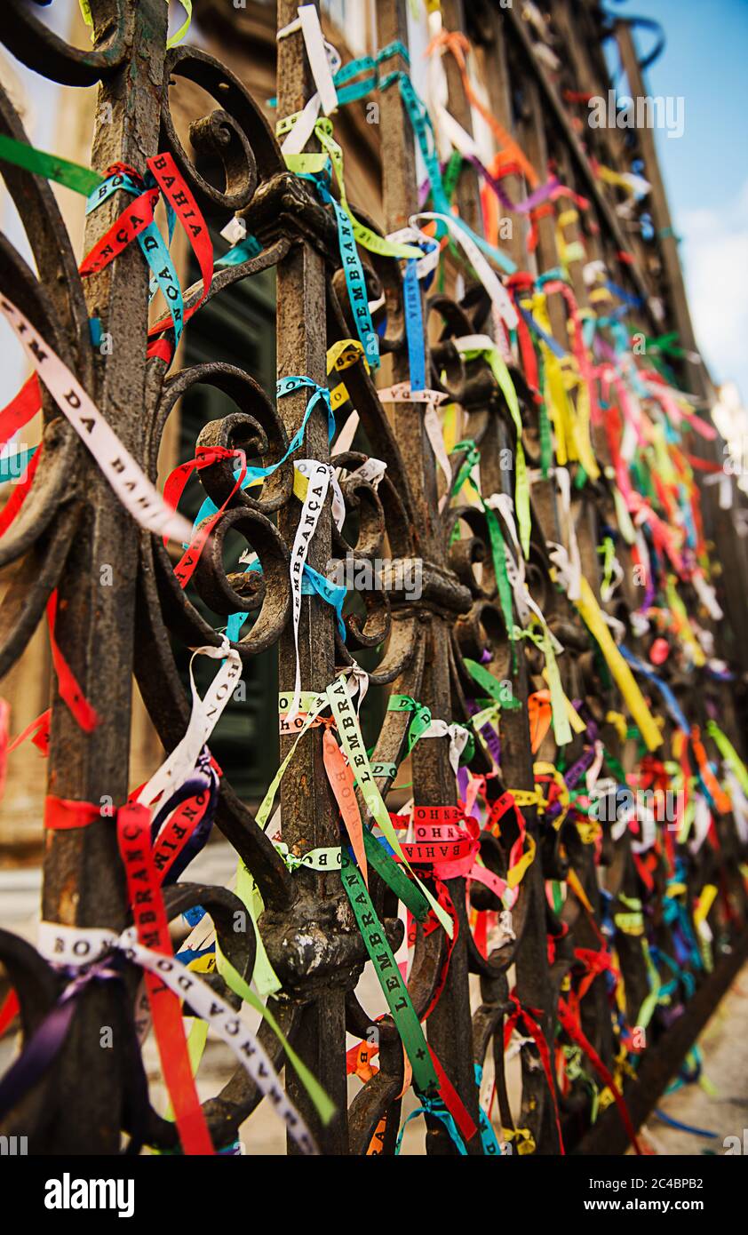 Colorful Bonfim ribbons tied to a gate outside a church in Salvador, Bahia Stock Photo