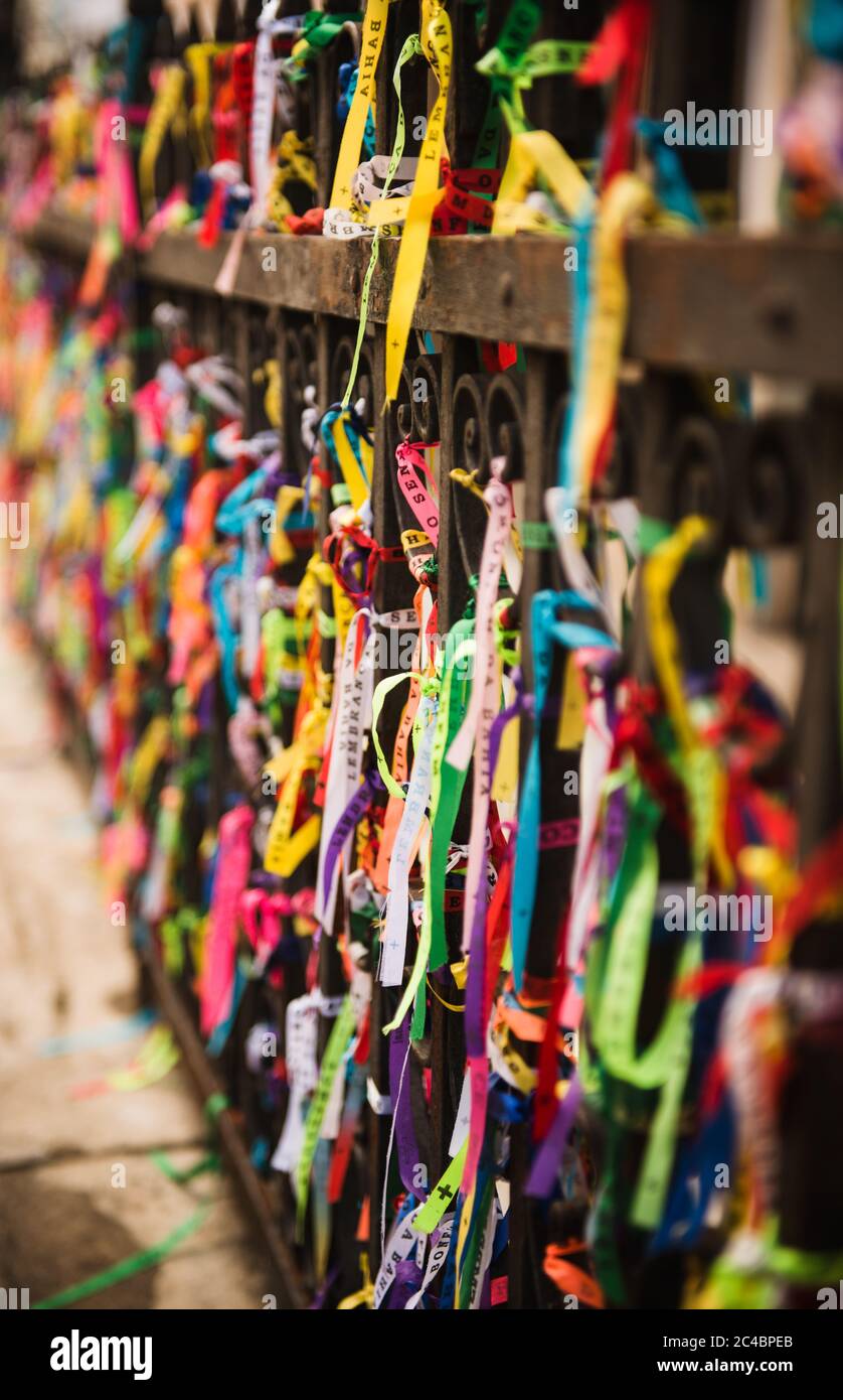 Colorful Bonfim ribbons tied to a gate outside a church in Salvador, Bahia Stock Photo