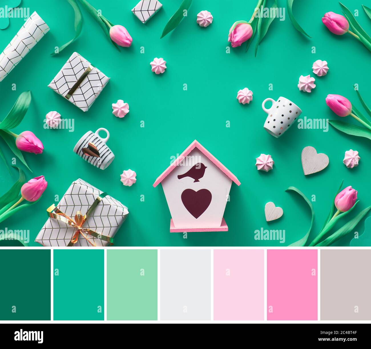 Color matching palette from flat lay image of Spring flat lay on green background. Birdhouse, white and gold coffee cups, pink tulips, gifts, hearts a Stock Photo