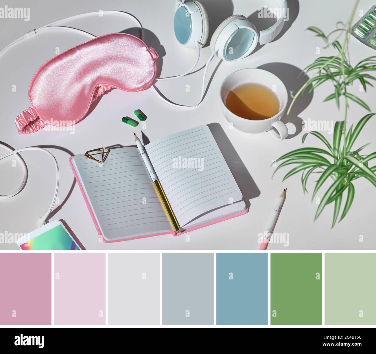 Color matching palette from healthy night sleep still life in pink and green. Sleep mask, earphones, tea, sleeping pills, diary notebook. Silver grey Stock Photo