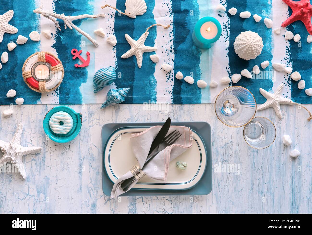 Contemporary nautical table setting with nautical sea decorations