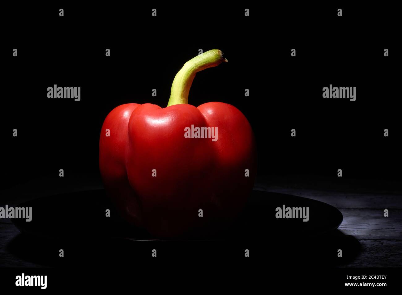red sweet pepper on a black background Stock Photo - Alamy