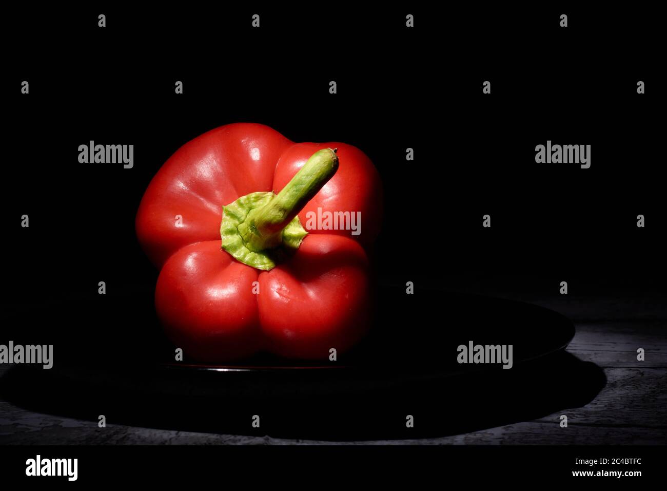 red sweet pepper on a black background Stock Photo - Alamy