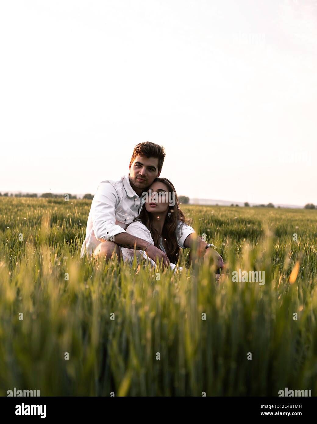 couple sitting in grass Stock Photo - Alamy