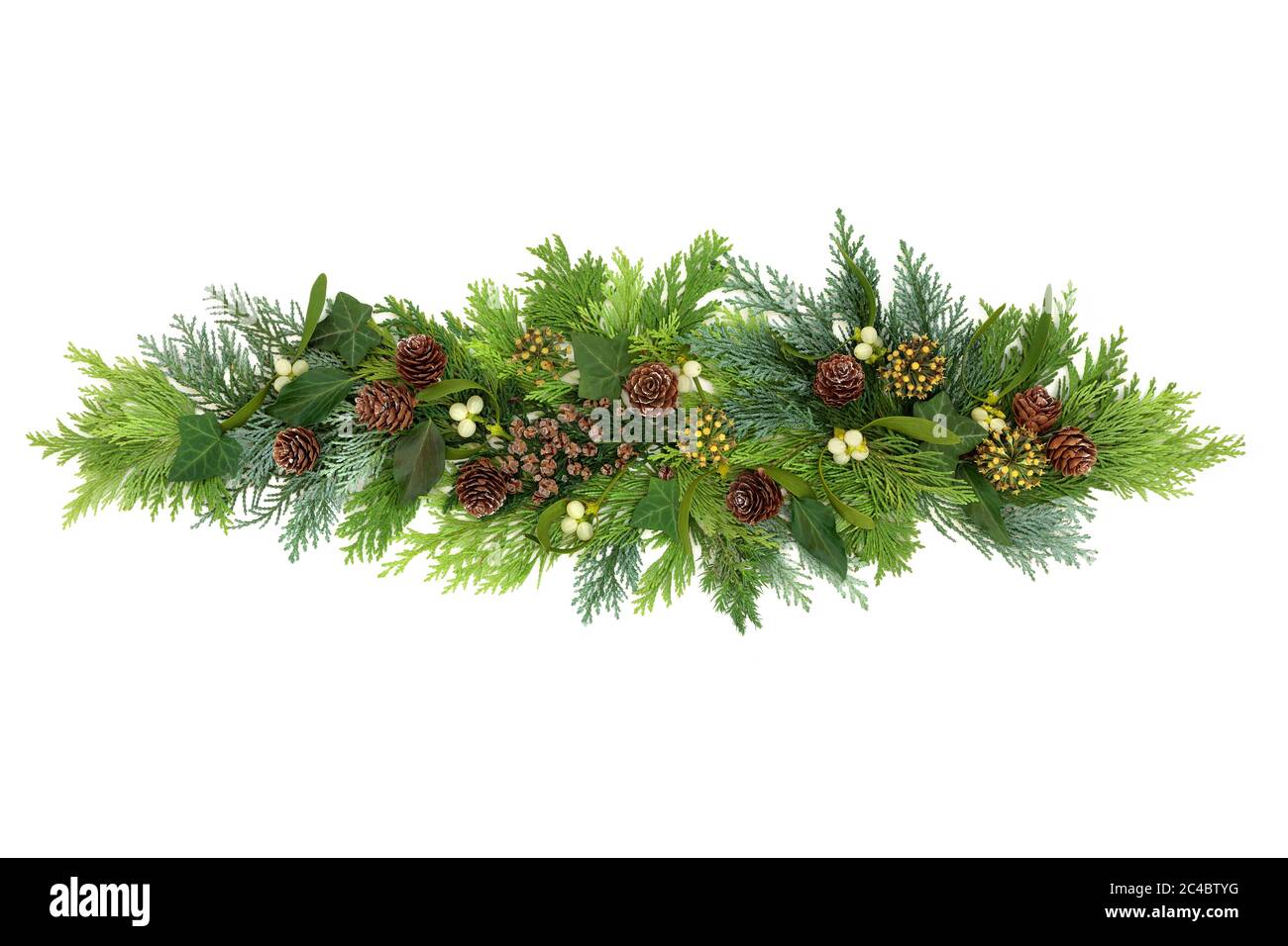Winter greenery decorative display with winter greenery of cedar cypress firs, mistletoe, ivy and pine cones on white background. Stock Photo
