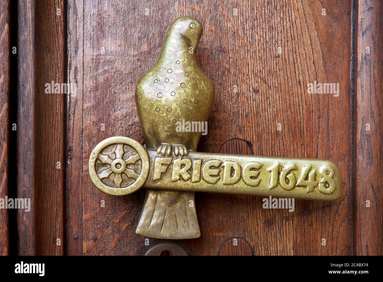 door handle in form of a dove with lettering Friede 1648, Peace of Westphalia on the town hall, Germany, Lower Saxony, Osnabrueck Stock Photo