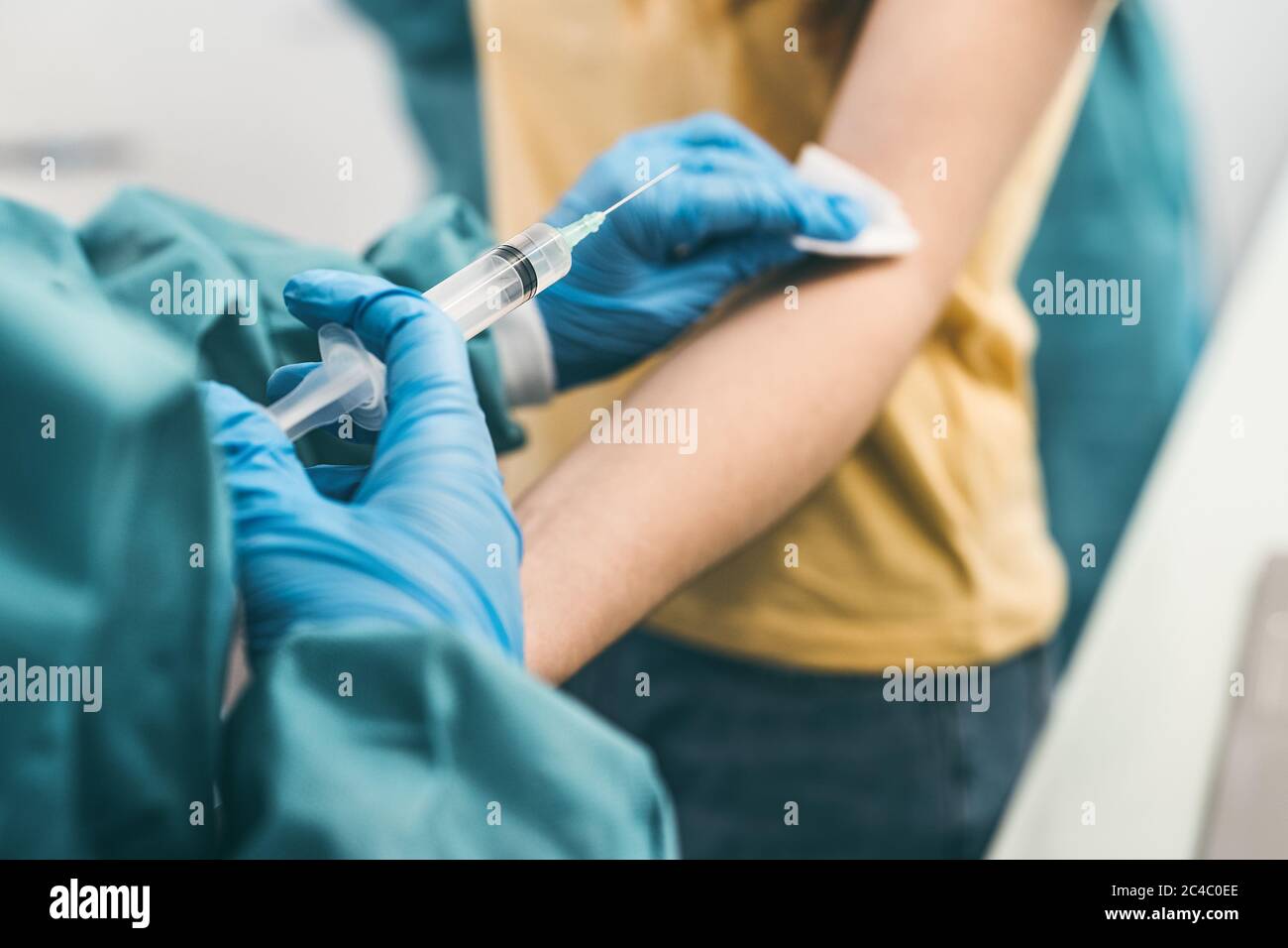 Close up woman doctor doing syringe vaccine in hospital for preventing a stop corona virus outbreak Stock Photo