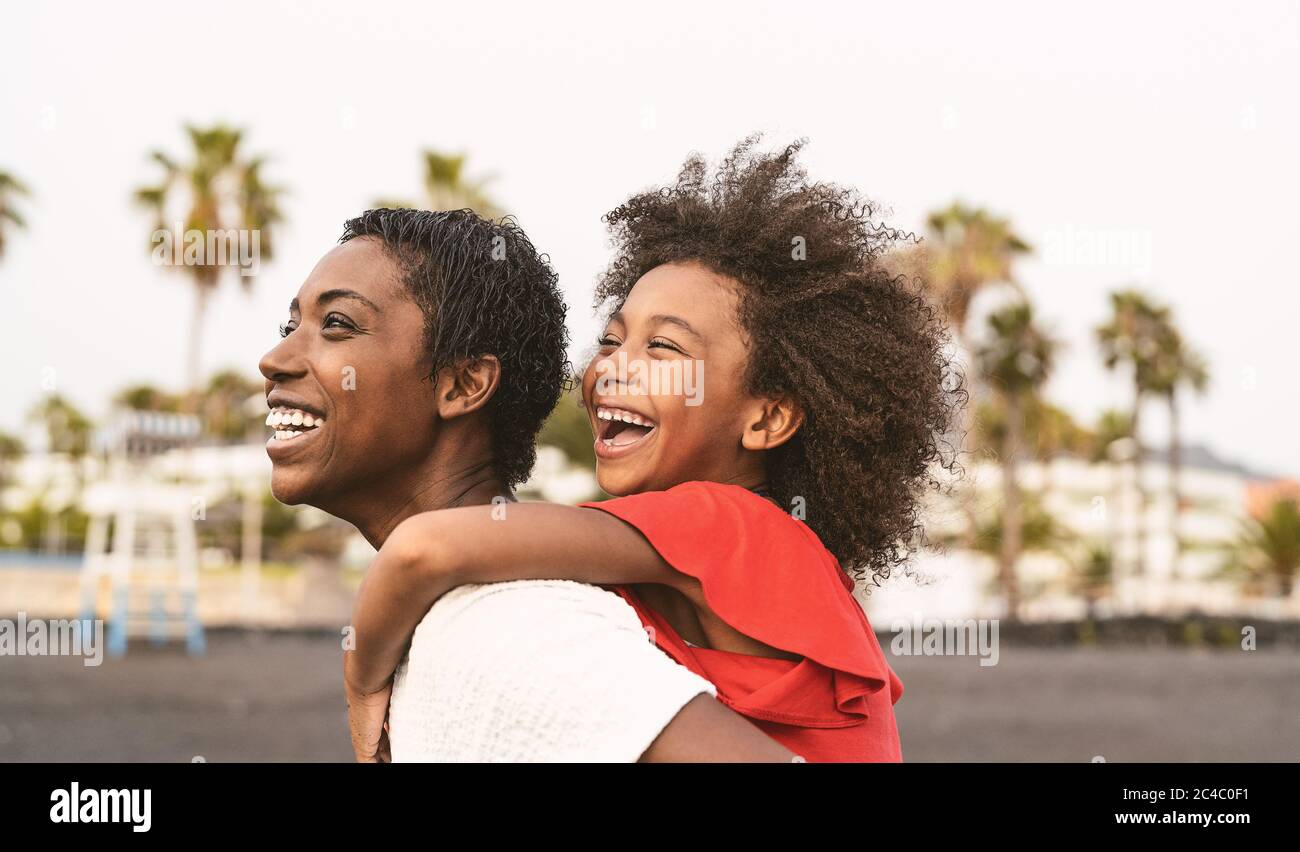 Happy African family on the beach during summer holidays Afro