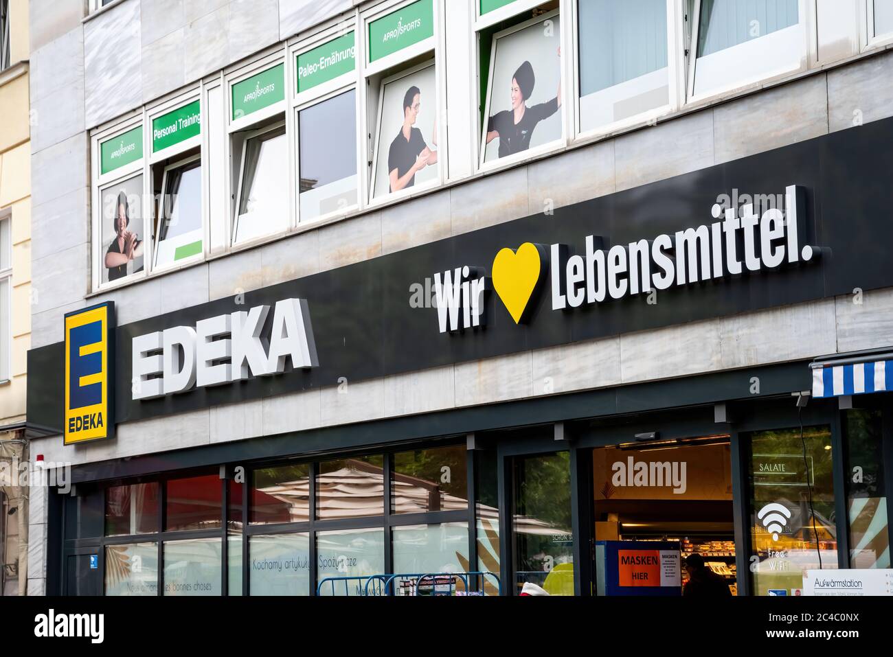 Berlin, Germany, 06/11/2020: Logo on the facade of an Edeka store in Berlin with text: Wir ...