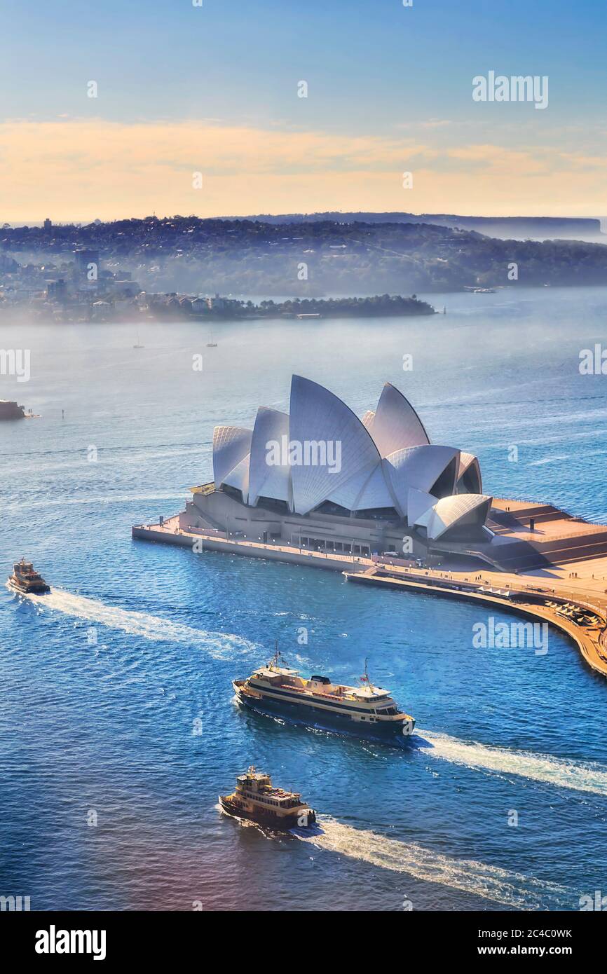 Blue waters of Sydney harbour with Ferries NSW on route to various destinations seen from altitude of Circular Quay towers. Stock Photo