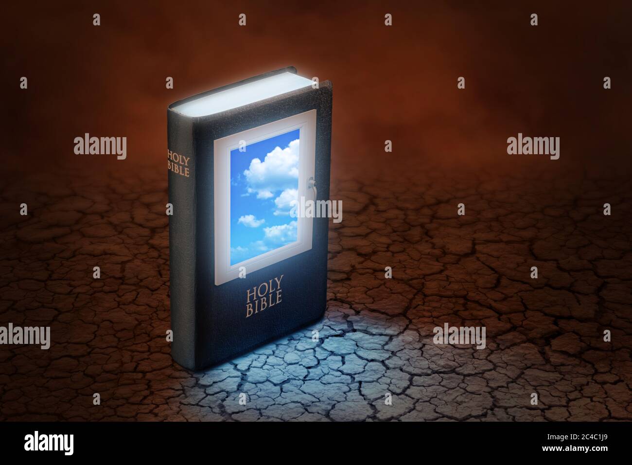 Holy Bible with a window on the cover through which blue sky can be seen, standing on a dry and cracked reddish earth. Concept about the Bible which i Stock Photo
