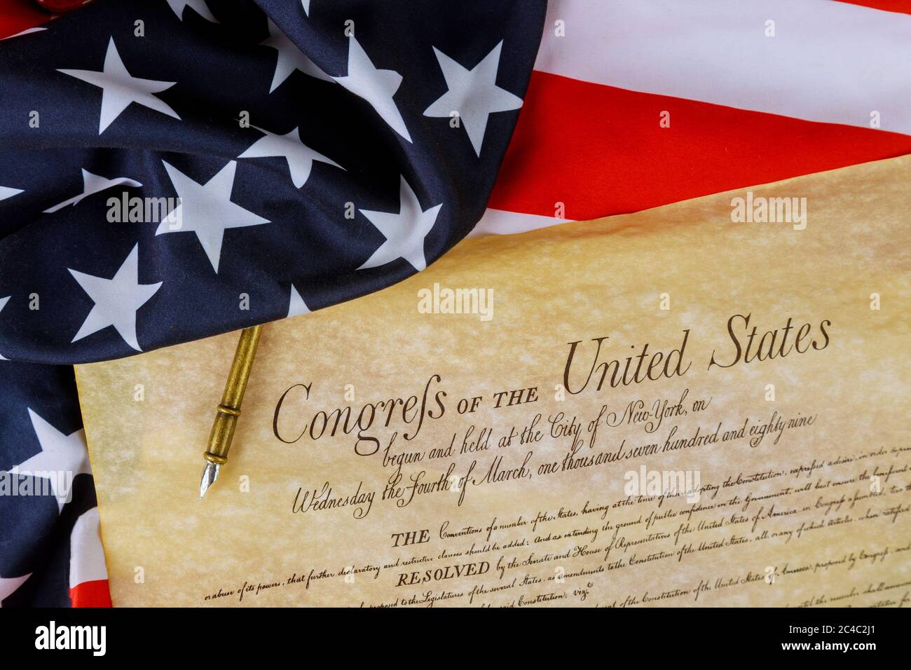 First pages of the National Archives copy created in the American constitution of the United States of America on close up on America flag. Stock Photo