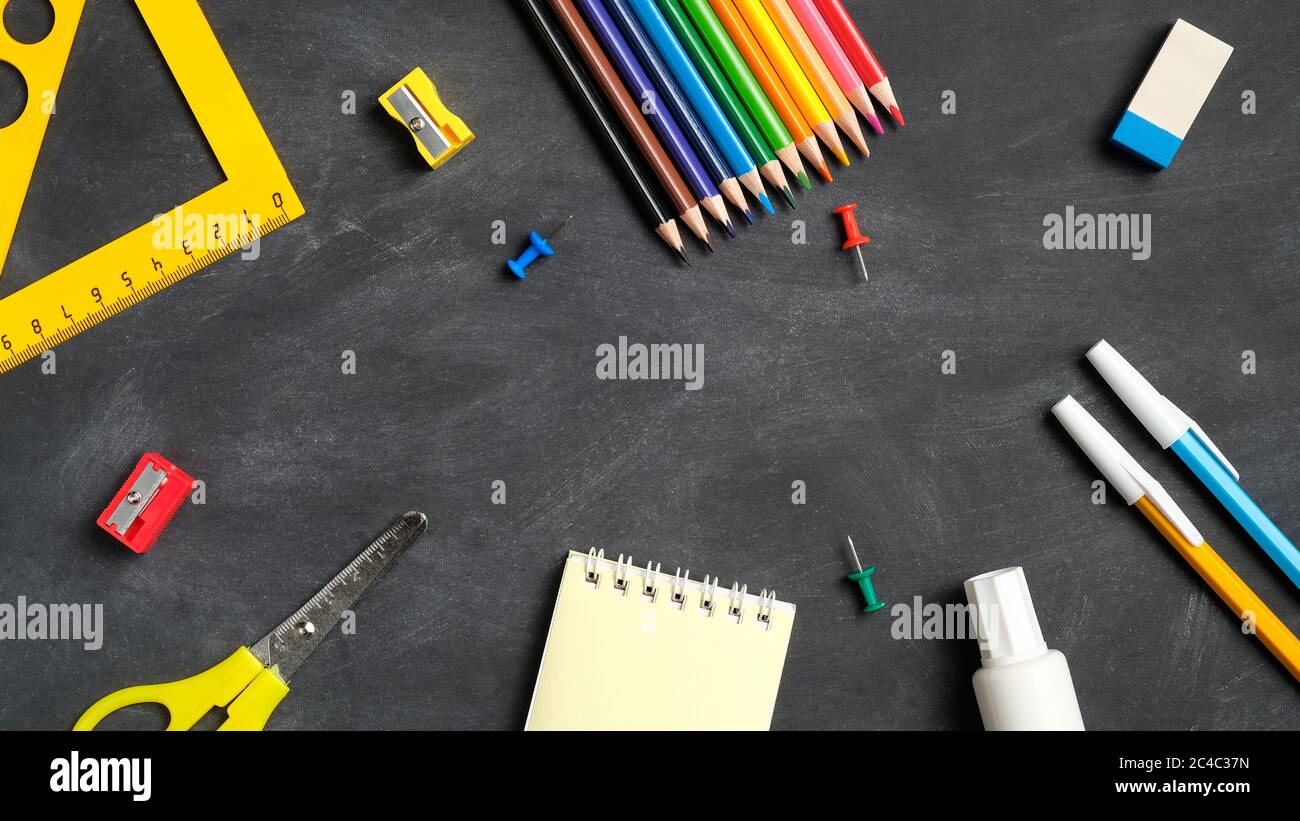 Back to school concept. Flat lay school supplies on black board ...