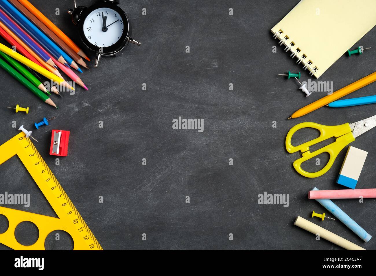 Back to school concept. Frame of school supplies on black board ...