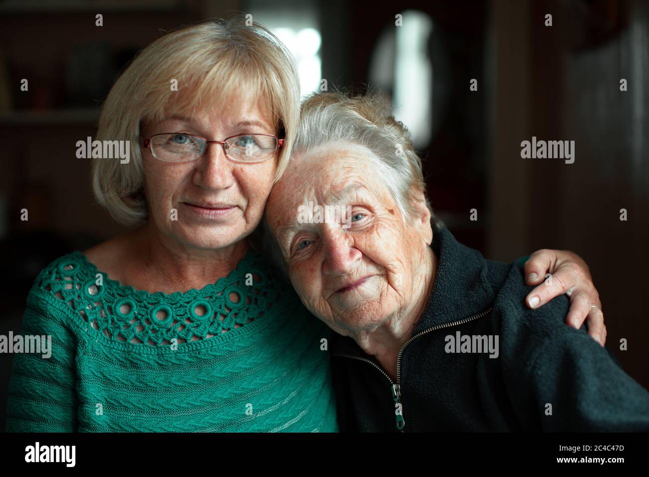 Portrait of a mature woman in an embrace with her old mother Stock Photo