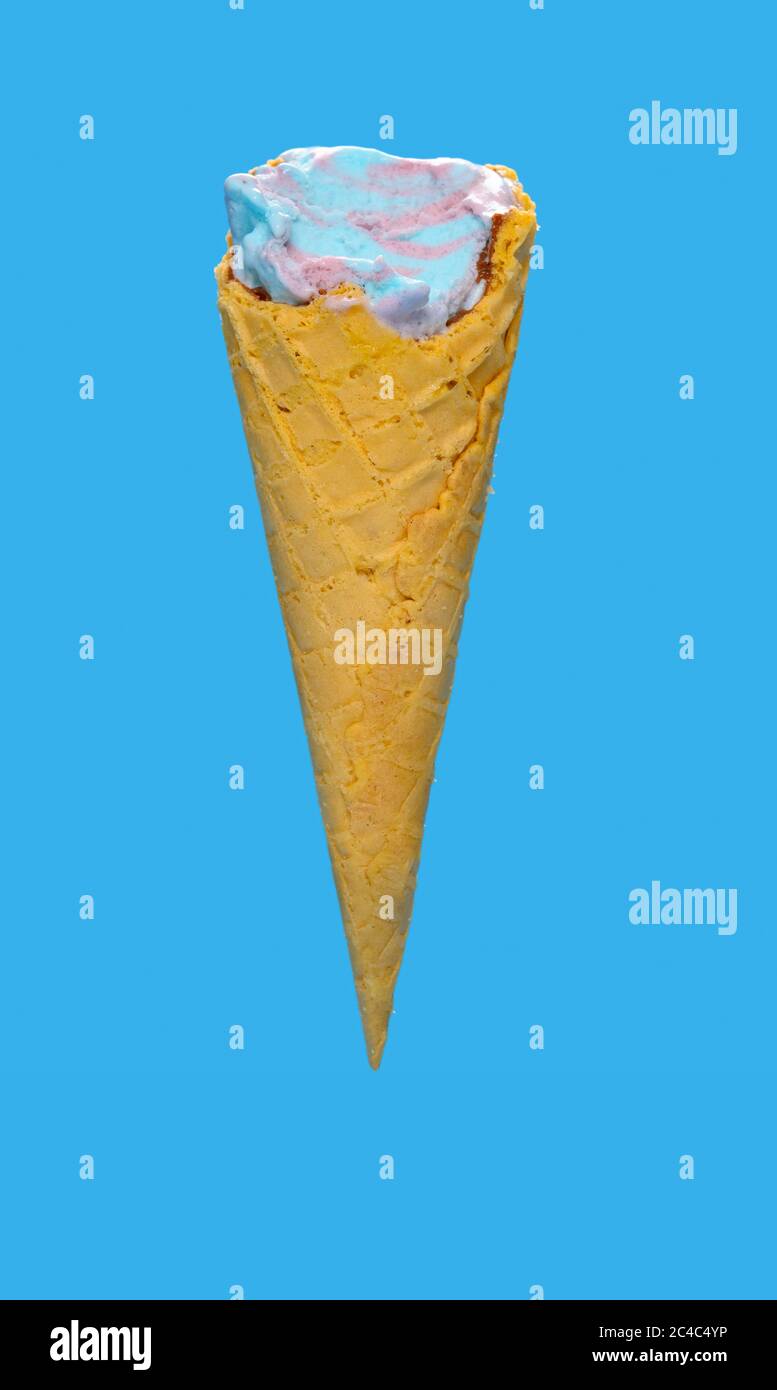 side view marshmallow and raspberry flavor ice cream cone with couple of bites on blue background Stock Photo
