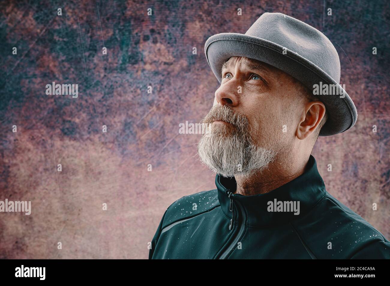 Older man with gray beard wearing a fedora Stock Photo