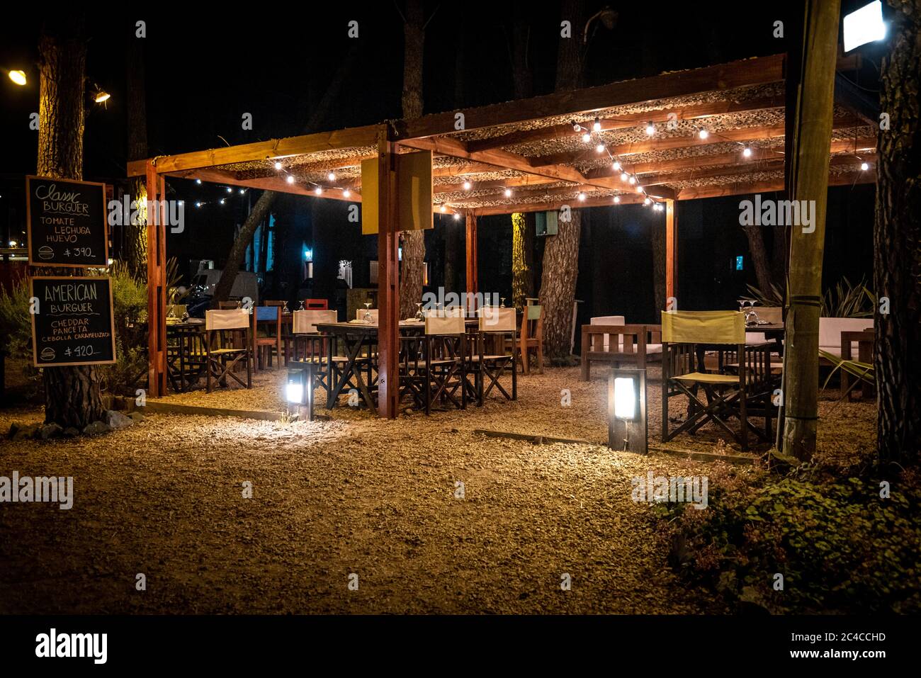 Night scene of an elegant outdoor bar illuminated by small hanging