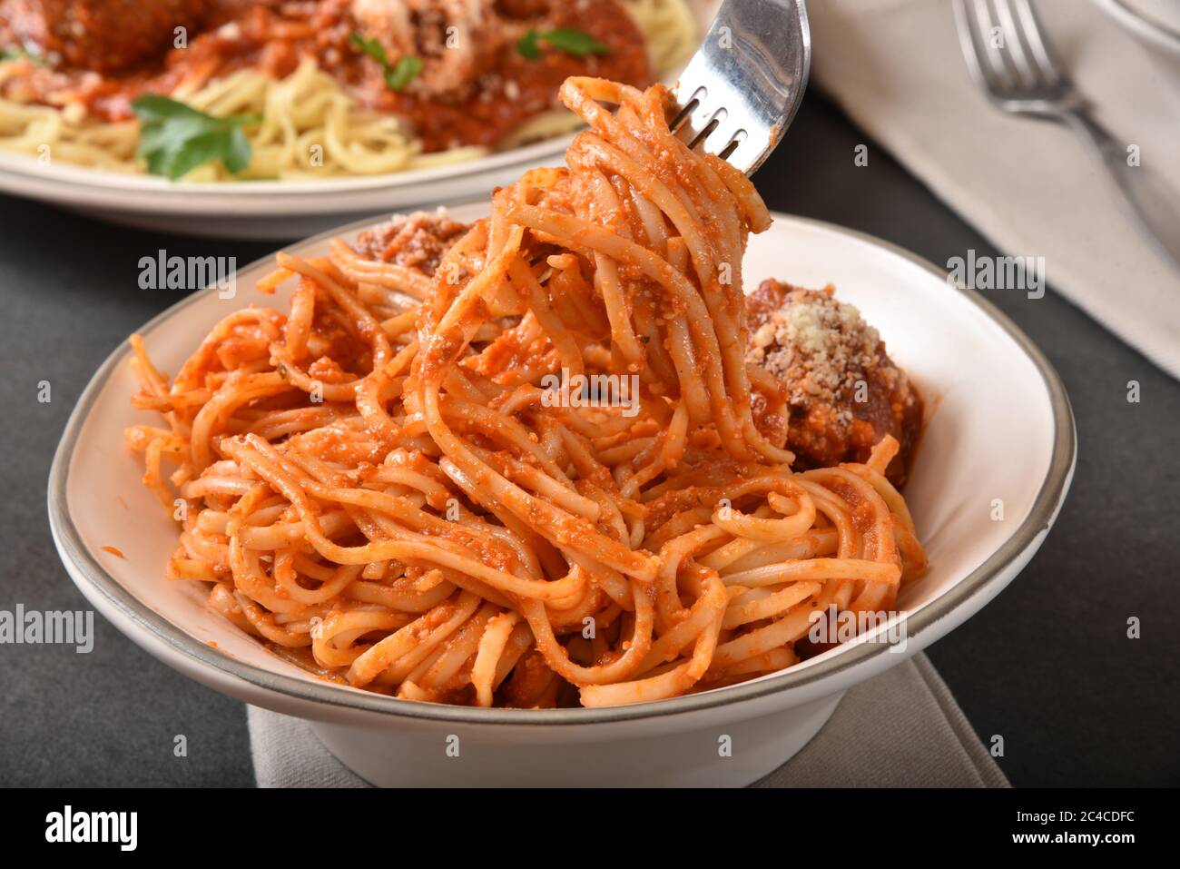 Taking a bite of gourmet spaghetti and meatballs Stock Photo