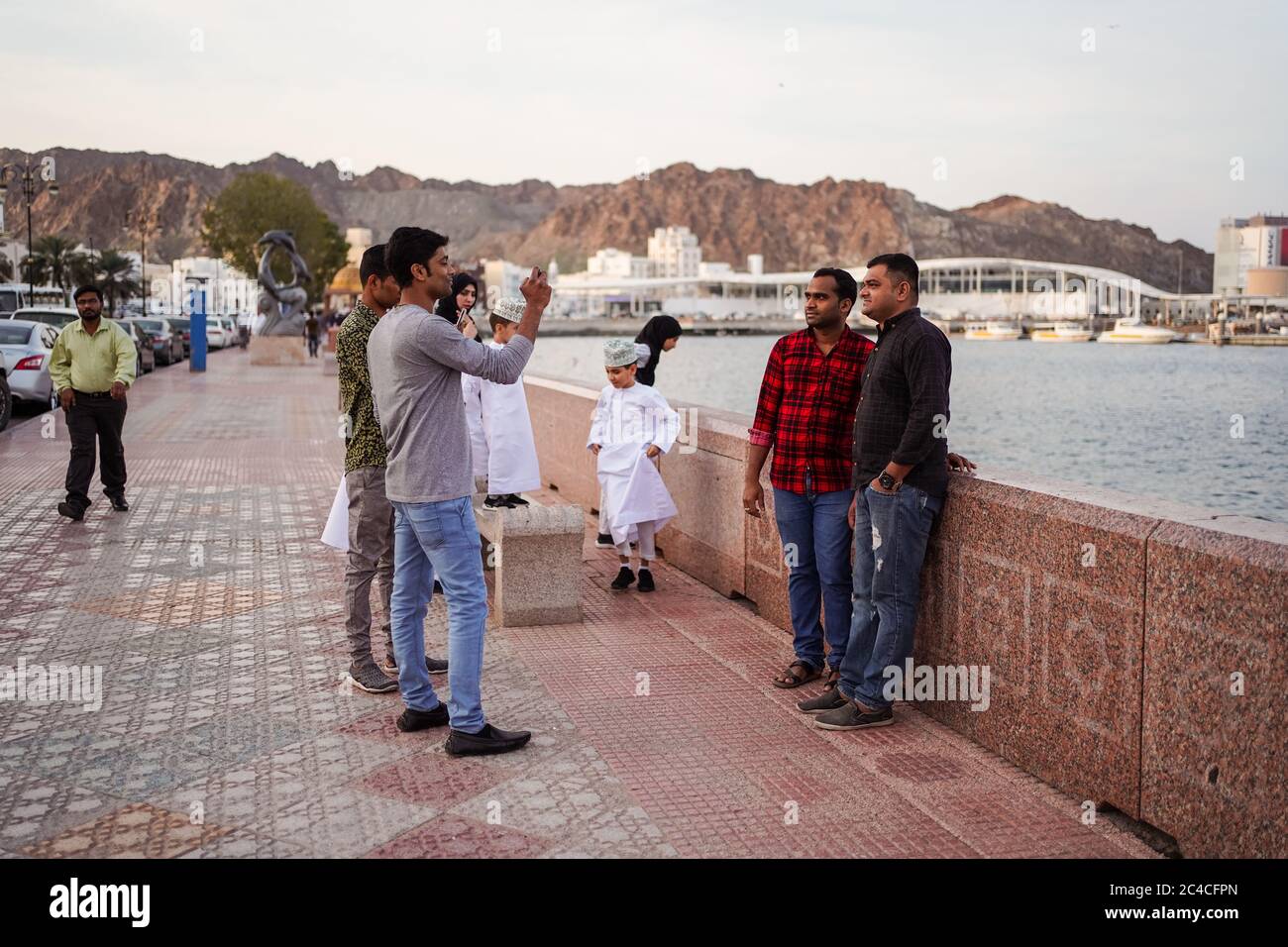 Muscat / Oman - 15, 2020: Muslim male friends enjoy leisure time photos in the Corniche of Muscat near Mutrah Souq Stock Photo - Alamy