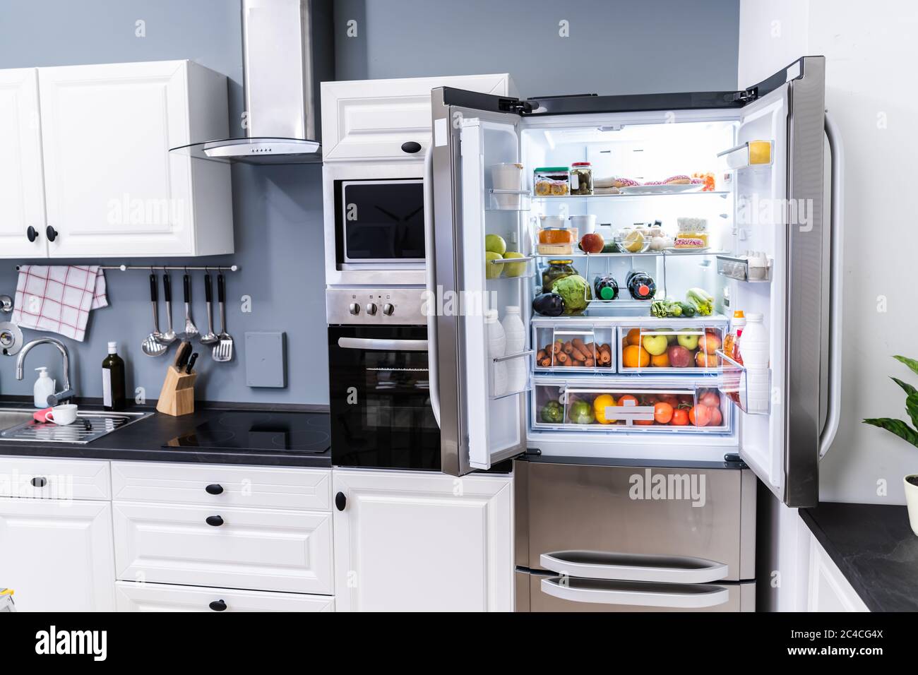 Open Refrigerator Or Fridge Door With Food Inside Stock Photo