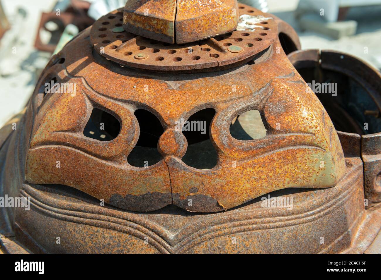 The rusty top of an antique wood burning stove Stock Photo