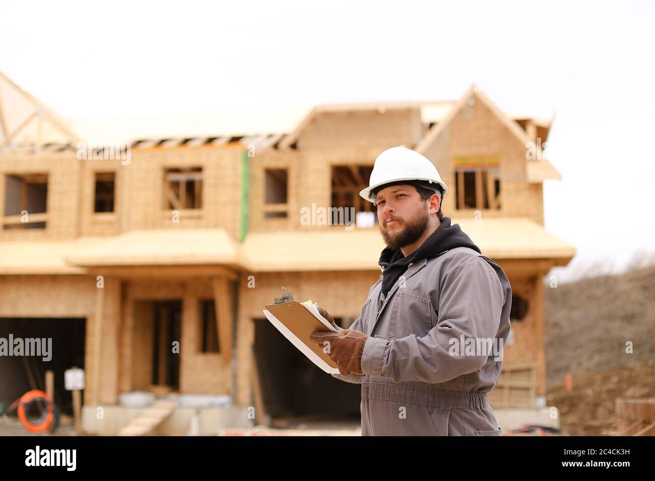 Engineer drawing plan in notebook at construction site. Stock Photo