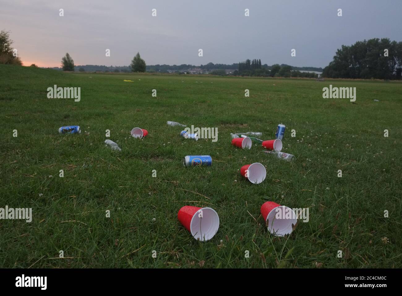 Hertford, UK. 26th June, 2020. A lot of rubbish has been left near bins and strewn across the park in Hartham Common after a sunny day yesterday. Harham Common is a park found near the town centre of of Hertford and the suburb of Bengeo. Credit: Andrew Steven Graham/Alamy Live News Stock Photo