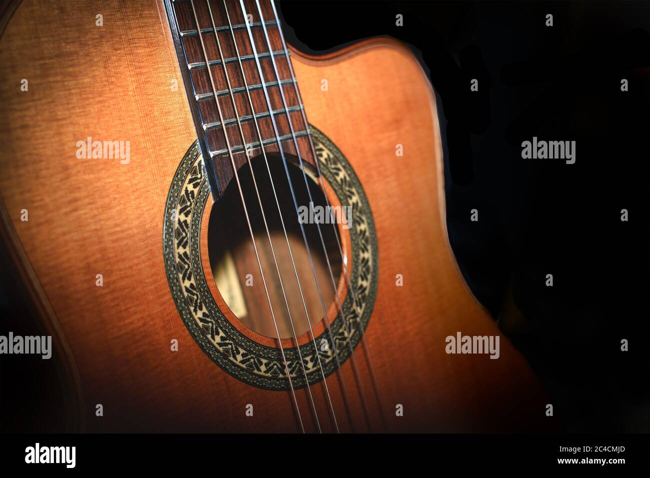 Classical guitar detail on black background Stock Photo