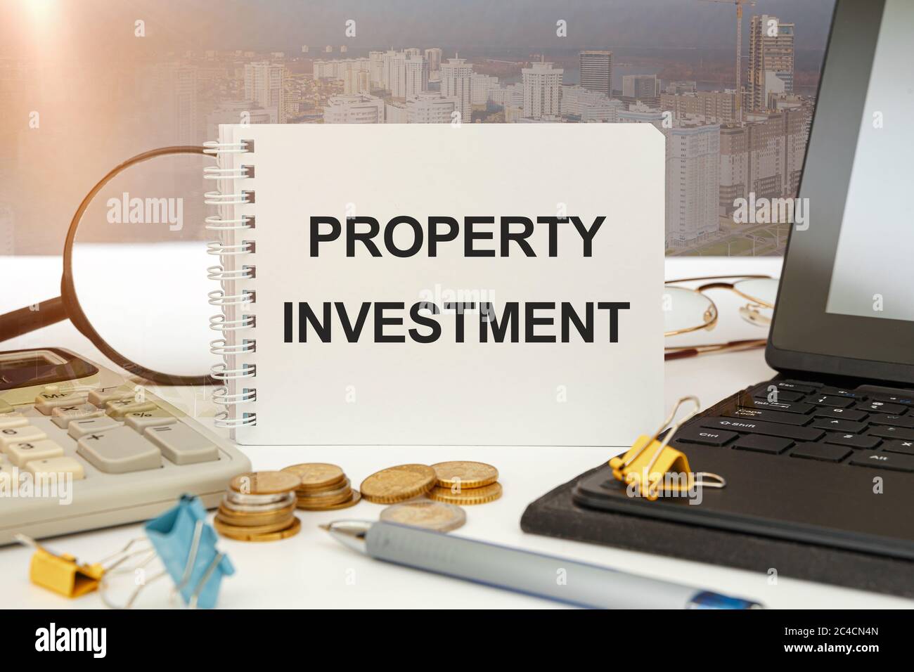 Workspace office desk and notebook writing Property Investment. Business property concept. Stock Photo