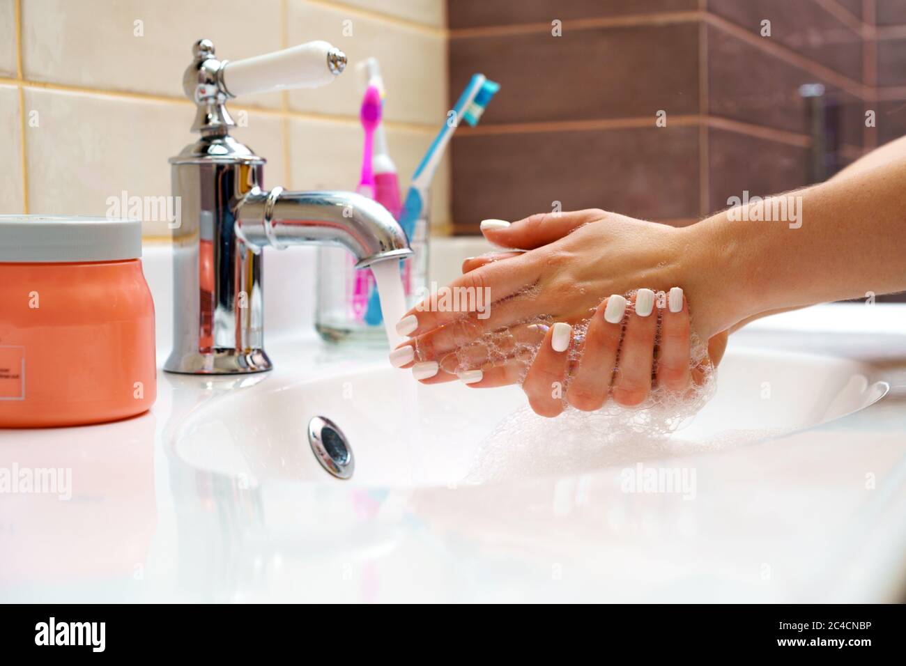 Woman washing her hands with soap close up Stock Photo - Alamy