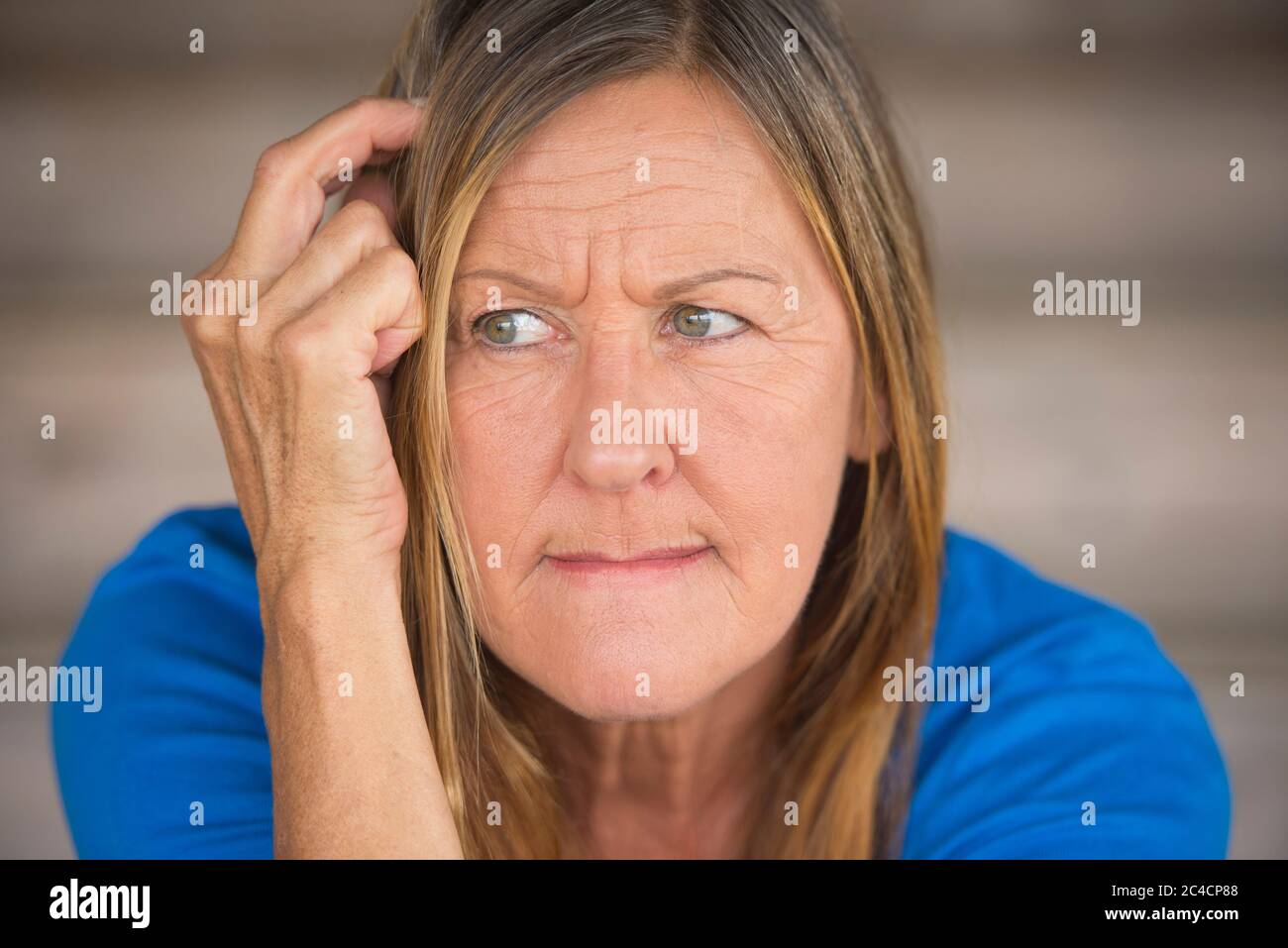 Portrait attractive mature woman with worried thoughtful angry expression, lonely and nervous, blurred background. Stock Photo