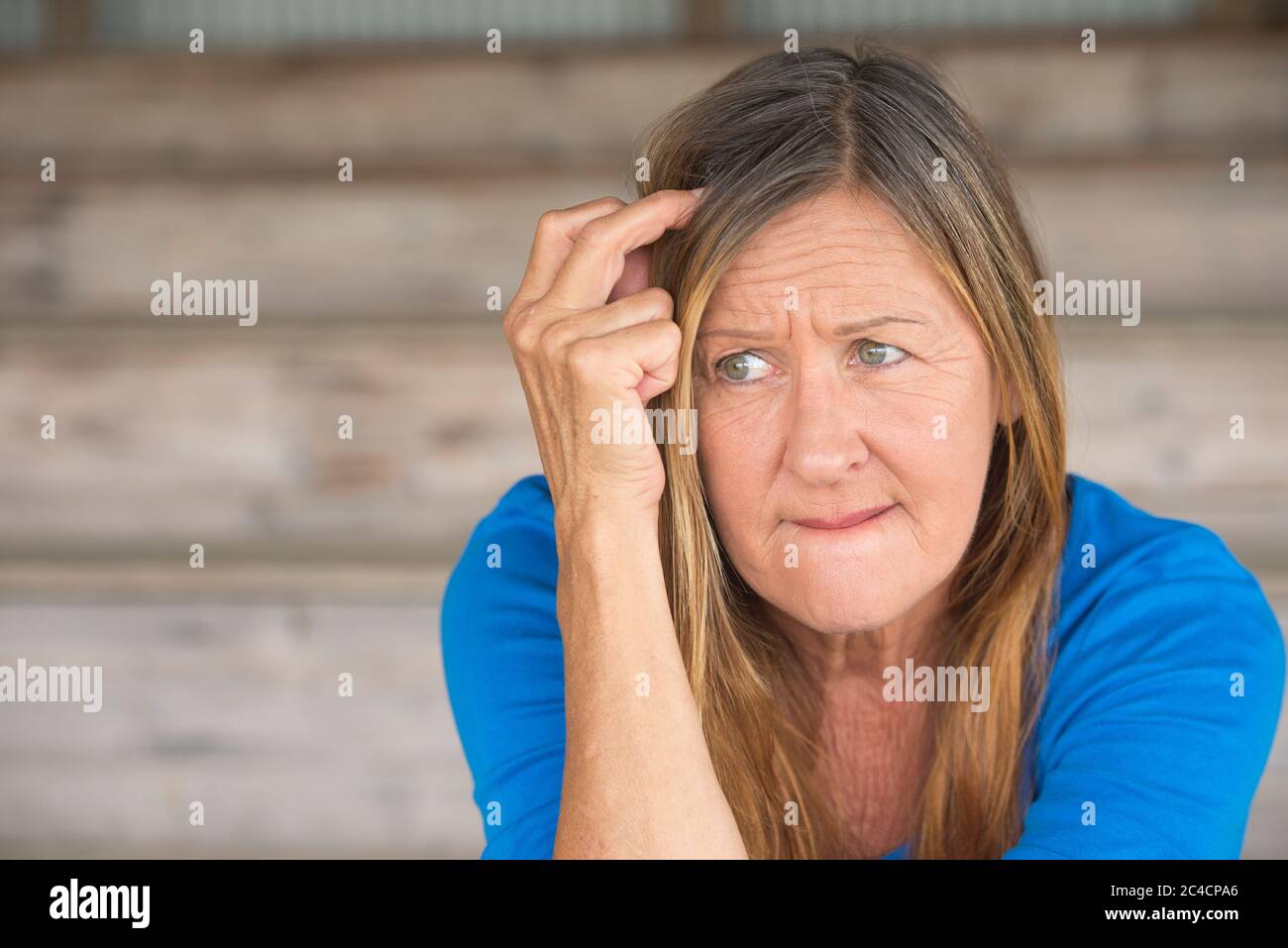 Portrait attractive mature woman with nervous thoughtful angry expression, lonely worried, blurred background. Stock Photo