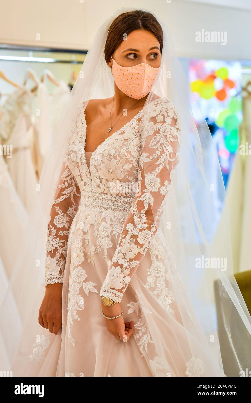 Jessica Letheren wears a face covering during a dress fitting at Allison Jayne Bridalwear in Clifton Bristol which has reopened following the lifting of coronavirus lockdown restrictions with measures...