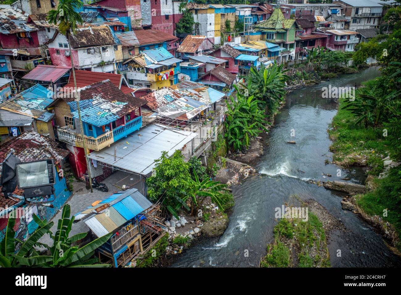 Colorful homes tightly packed together along a river in Indonesia. Stock Photo