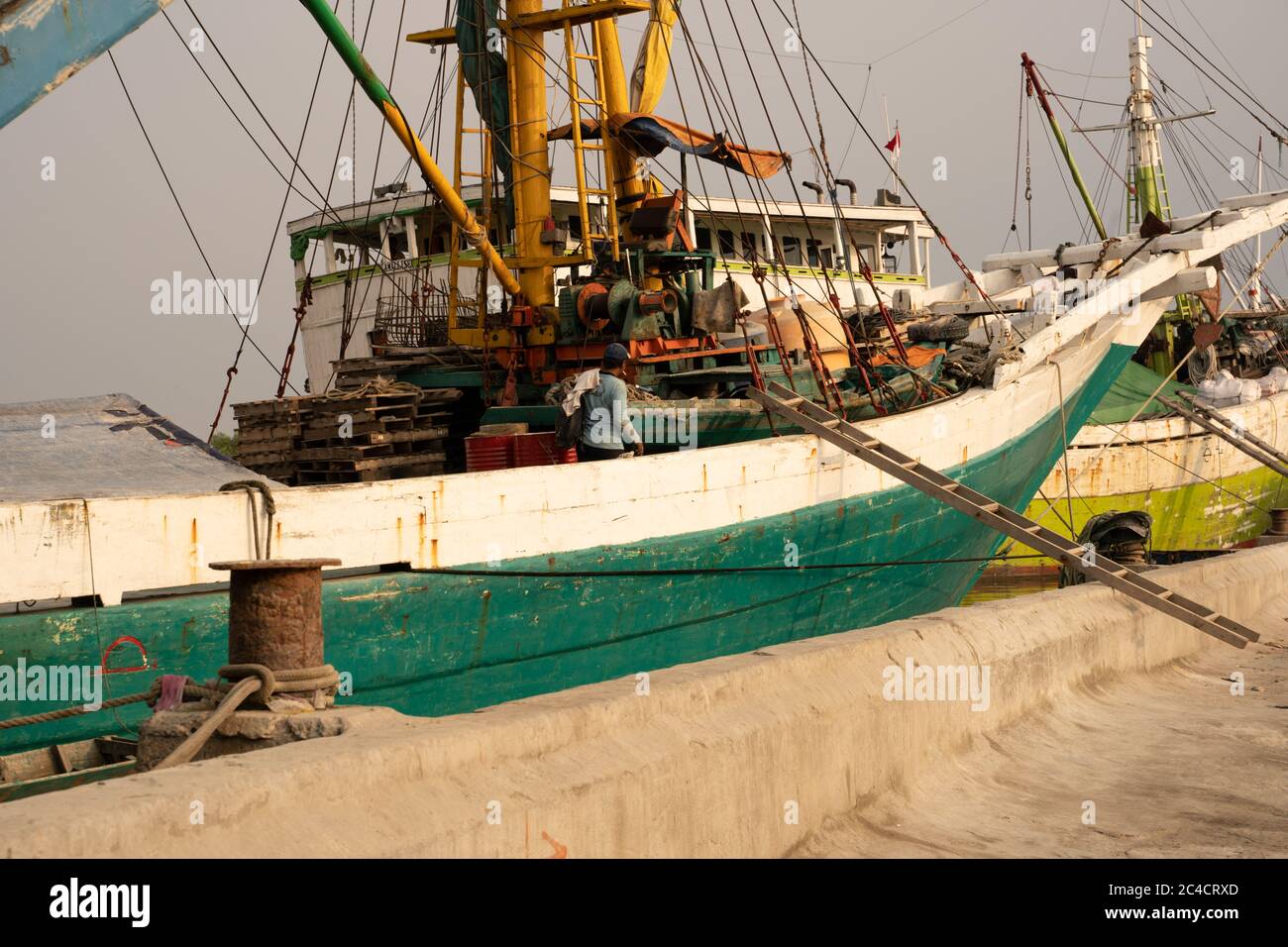 A shipworker heading ashore for his weekend break at Sunda Kelapa Habour in Jakarta. Stock Photo