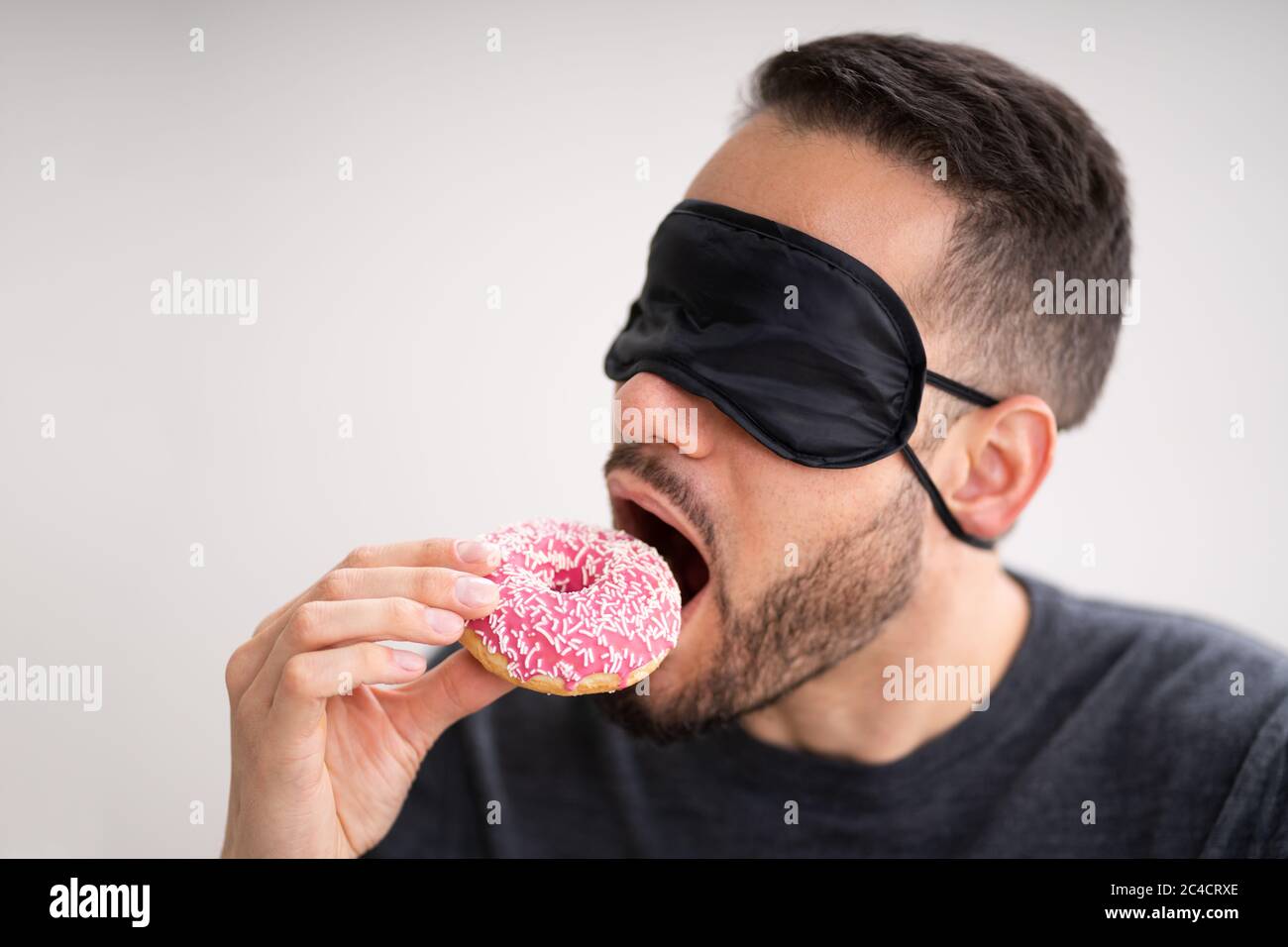 Blind Taste. Blindfolded Food Test. Man Face Stock Photo