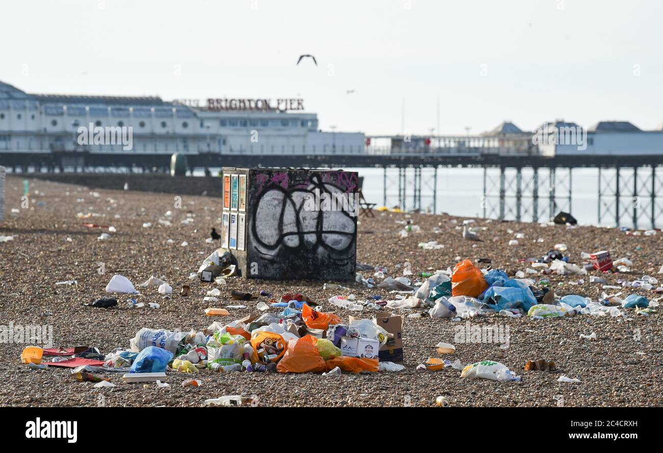Brighton UK 26th June 2020 - Piles of litter on Brighton beach and seafront this morning which has been left behind by the crowds of visitors yesterday which was the hottest day of the year so far  : Credit Simon Dack / Alamy Live News Stock Photo