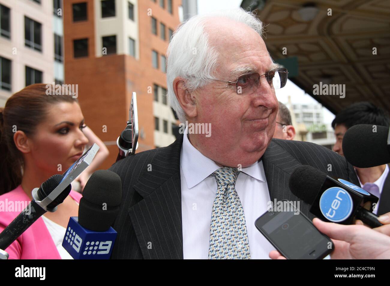 Barrister Greg James QC is surrounded by a media scrum as he leaves the