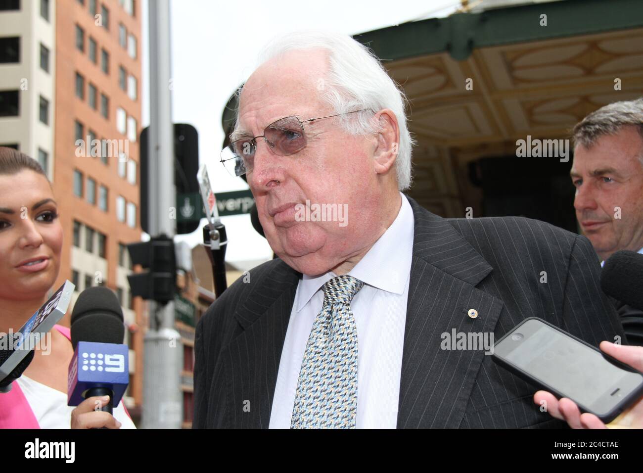 Barrister Greg James QC is surrounded by a media scrum as he leaves the