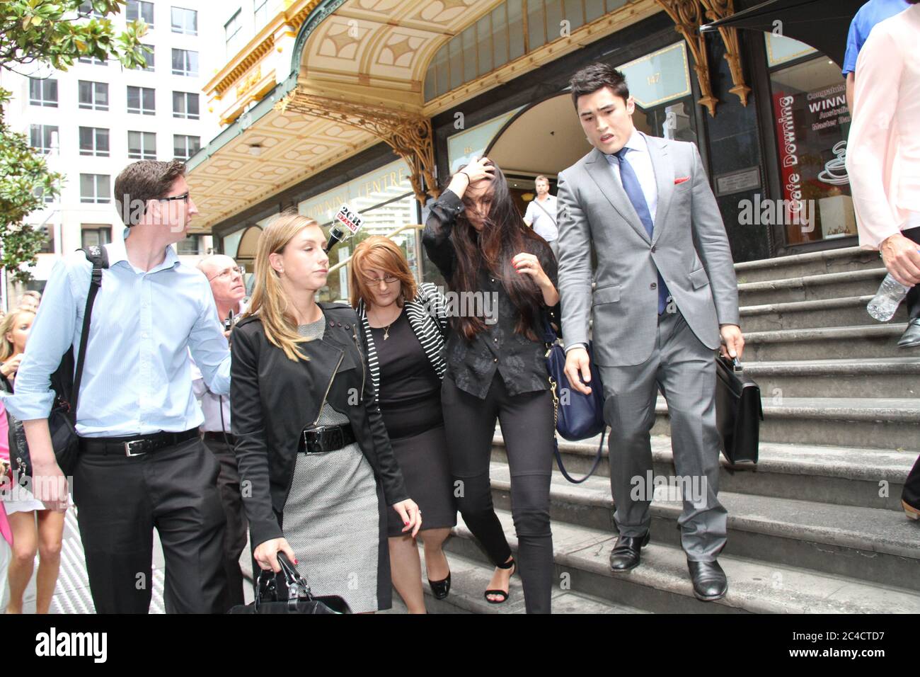 Russell Packer’s partner Lara Wilcox is surrounded by a media scrum as