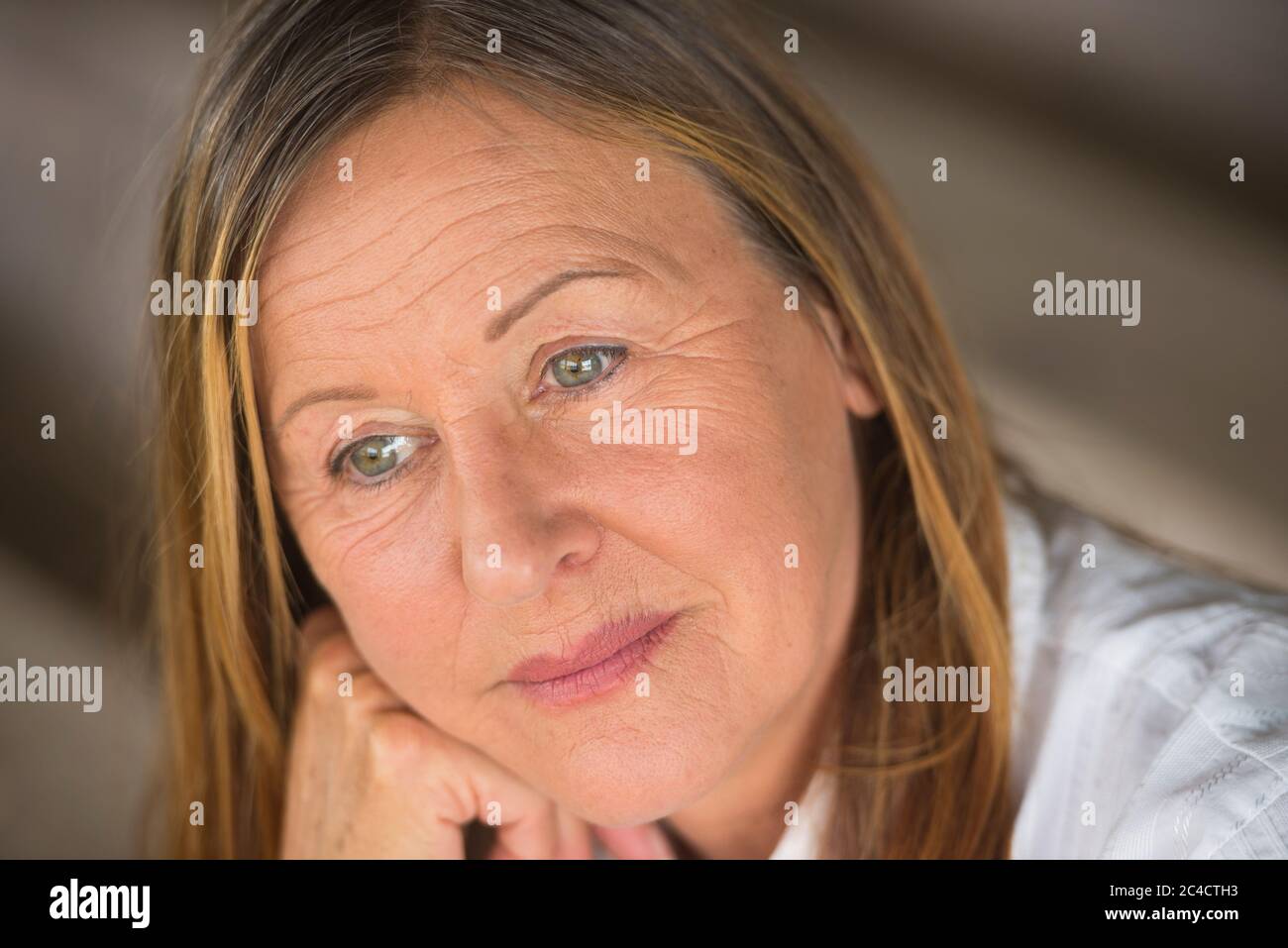 Portrait attractive mature woman with serious happy confident facial expression, thoughtful, blurred background. Stock Photo