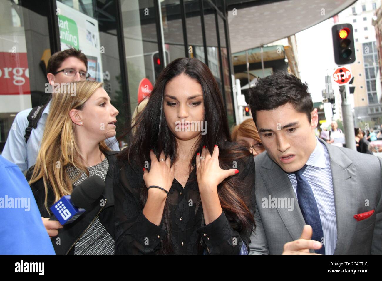 Russell Packer’s partner Lara Wilcox is surrounded by a media scrum as