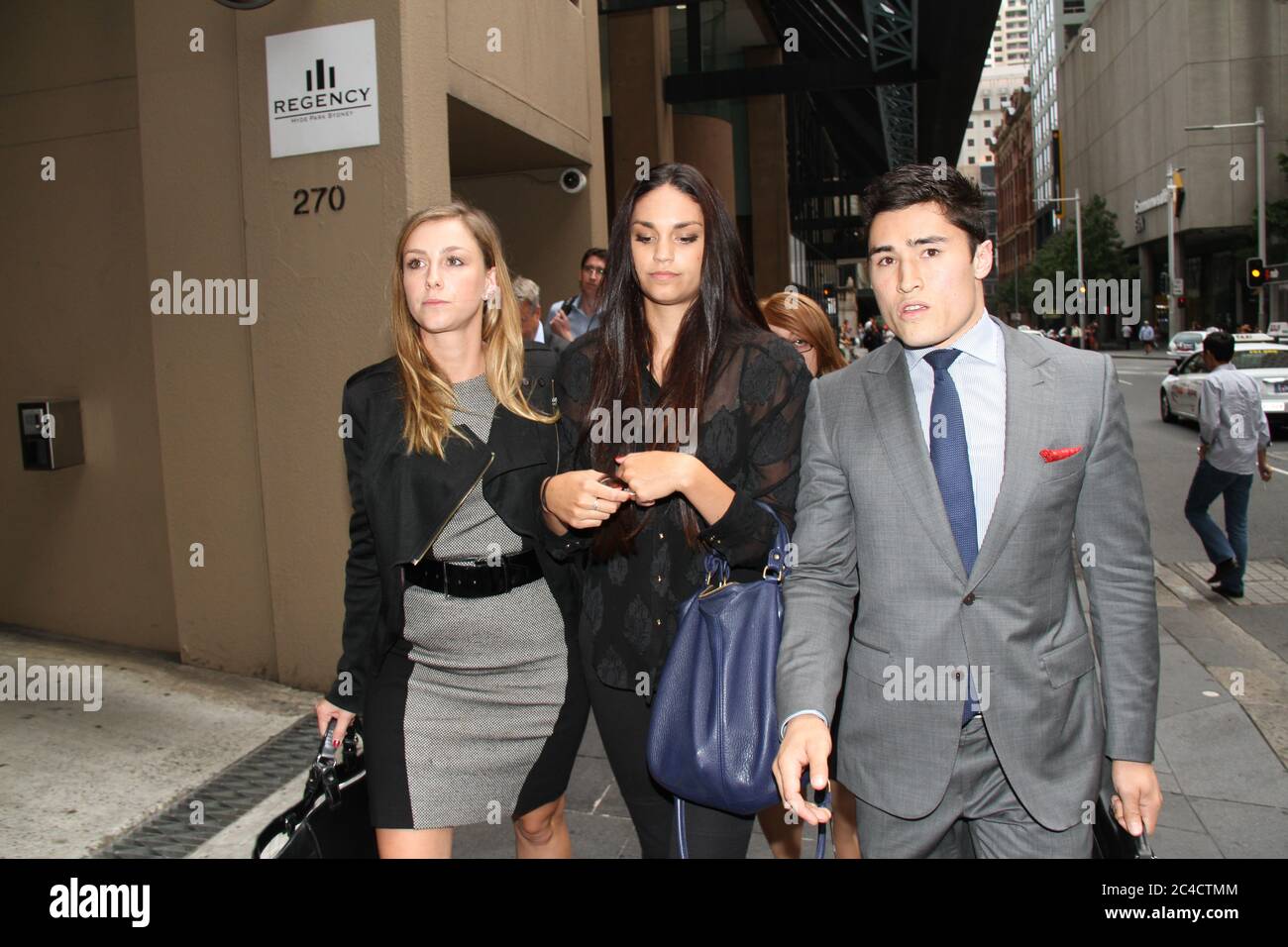 Russell Packer’s partner Lara Wilcox is surrounded by a media scrum as