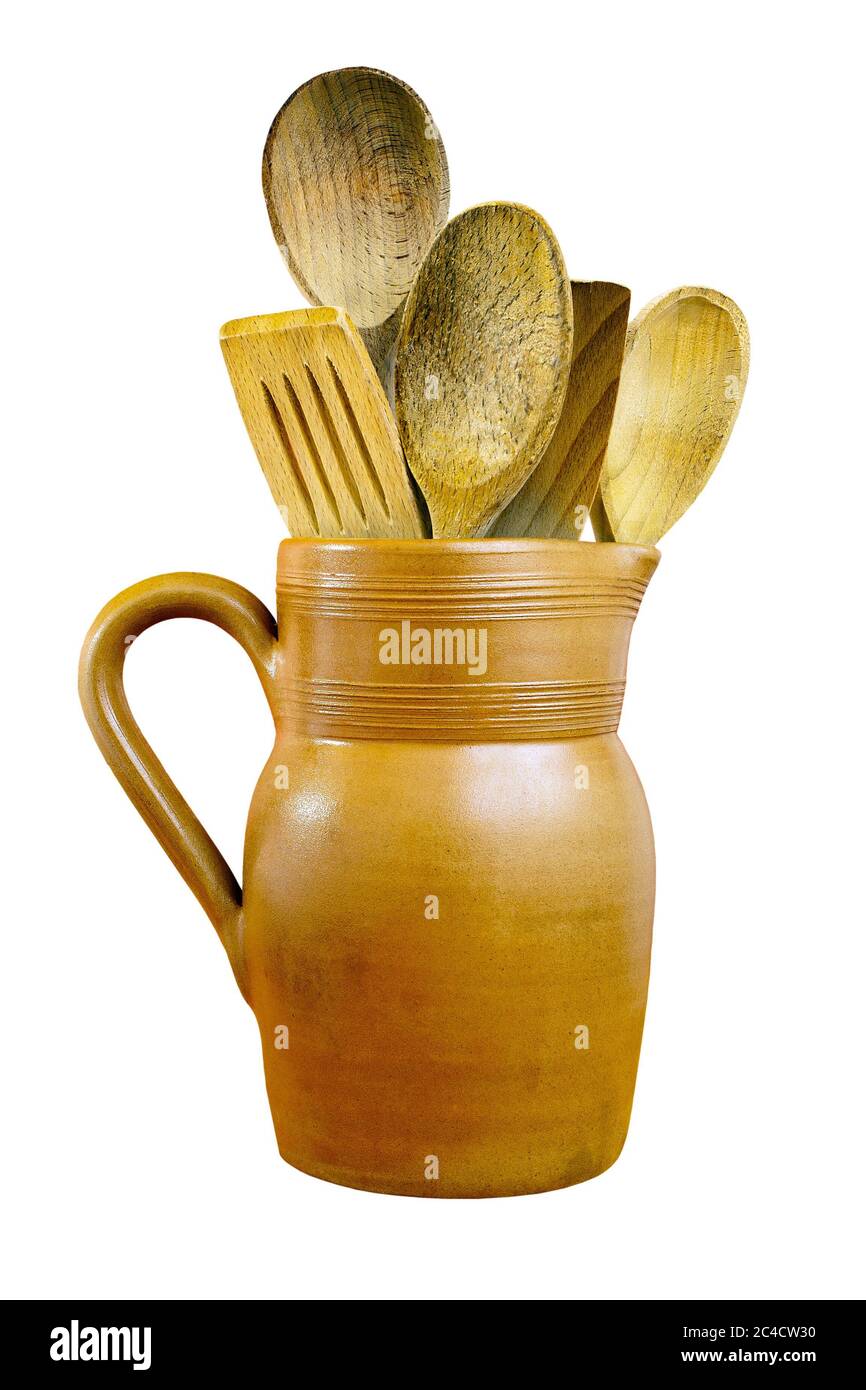 Clay jug and wooden spoons on isolated white background with a clipping