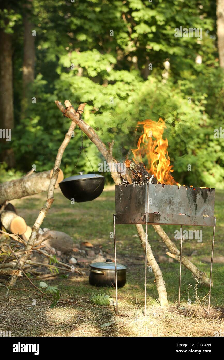 Cooking meat outdoors in a castiron pot. Summer outdoor activities
