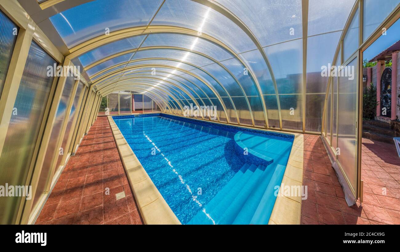 Covered summer pool. The covered area of the outdoor pool for hotel