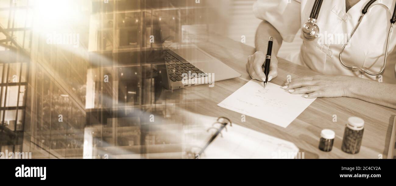 Female doctor writing prescription in medical office; multiple exposure ...