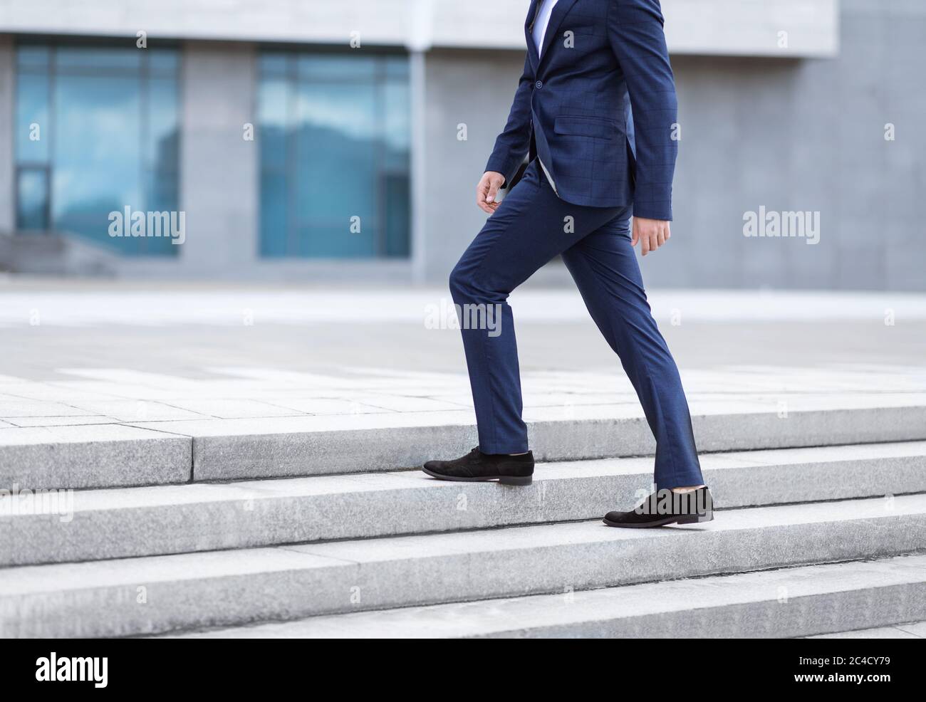 Corporate employee going up stairs on way to his work near office